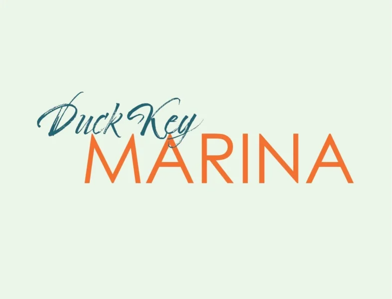 The image displays the text "Duck Key MARINA" with "Duck Key" in a blue script font and "MARINA" in large, orange, capital letters on a light background.